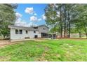 Expansive backyard featuring a screened in porch, mature trees and a well maintained lawn at 1094 Amber Sw Rdg, Lilburn, GA 30047