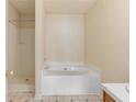 A clean bathroom with a shower and a separate tub for a relaxing bathing experience at 131 Tye St, Stockbridge, GA 30281