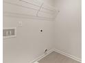 Clean and simple laundry room with tiled floors and plenty of shelving at 52 Leggett Dr # 185, Villa Rica, GA 30180