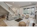 Bright open-concept living room featuring a large window, comfortable seating, and modern design at 1168 Mado Loop, Chattahoochee Hills, GA 30268