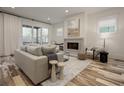 Inviting living room with a comfortable couch, fireplace, and bright windows showcasing modern design at 1168 Mado Loop, Chattahoochee Hills, GA 30268