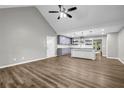 Open-concept living area with wood floors, vaulted ceiling, and a modern kitchen island at 3927 Airline Rd, Mcdonough, GA 30252