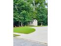 Backyard shed sits at the back of the property and features a gray exterior with white trim at 7052 Camp Falls Ct, Winston, GA 30187