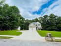 A stunning home with a charming shed, pristine landscaping, and a long drive to a two-car garage at 7052 Camp Falls Ct, Winston, GA 30187