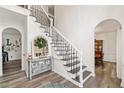 Elegant foyer with staircase with iron railing, decorative mirror, and access to multiple rooms at 1039 Avery Creek Dr, Woodstock, GA 30188