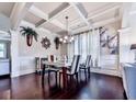 Formal dining room with coffered ceilings, elegant decor, and a stylish table set at 423 Livingston Pt, Acworth, GA 30102