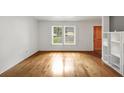 Inviting living space with wood floors, bright white walls, and natural light from double windows at 57 Cantey Nw Pl, Atlanta, GA 30327