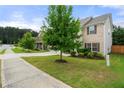 Lovely view of the yard with mature trees surrounding the home's exterior at 2680 Lower Village Dr, Ellenwood, GA 30294