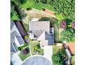 Aerial view of a home showcasing its roof, landscaping, driveway, and surrounding neighborhood at 3954 Rhyne Se Way, Smyrna, GA 30082