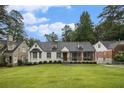 Beautifully landscaped front yard with a lush lawn and mature trees surrounding a well maintained home at 879 Wildwood Ne Rd, Atlanta, GA 30324