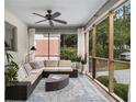 Relaxing screened porch features comfortable seating, stylish decor, and a ceiling fan for year-round enjoyment at 879 Wildwood Ne Rd, Atlanta, GA 30324