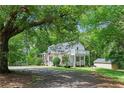 Exterior home nestled among lush trees and greenery in a natural setting at 121 Gosdin Rd, Palmetto, GA 30268