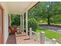 Relaxing front porch with outdoor seating, offering a tranquil view of the surrounding nature at 121 Gosdin Rd, Palmetto, GA 30268