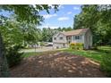 View of home's side elevation showcasing the home's placement in a wooded setting at 208 Bruce Ct, Dallas, GA 30157