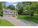 Inviting home with a neatly manicured lawn and a long driveway leading to a two-car garage at 208 Bruce Ct, Dallas, GA 30157