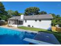 Refreshing backyard pool with diving board and screened patio, perfect for outdoor relaxation at 2136 Briarwood Ct, Snellville, GA 30078