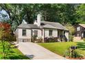 Attractive home featuring a long driveway and a beautifully landscaped front yard at 103 Willow Wood Se Cir, Atlanta, GA 30317