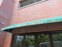 Close up shot of 115 West Peachtree Place building's awning and entrance with brick exterior at 115 W Peachtree Nw Pl # 702, Atlanta, GA 30313