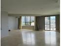 Spacious living room with tile flooring, large windows, and city views at 115 W Peachtree Nw Pl # 702, Atlanta, GA 30313