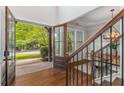 Staircase near an entry with hardwood floors and glass panel entry door at 2544 Thompson Ne Rd, Brookhaven, GA 30319