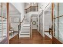 Grand foyer with staircase, hardwood floors, and modern sliding barn door at 2544 Thompson Ne Rd, Brookhaven, GA 30319