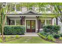 Inviting front entrance featuring a double door, manicured bushes, and stone walkway at 2544 Thompson Ne Rd, Brookhaven, GA 30319