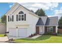 Charming two-story home with a two-car garage and well-maintained front yard at 7033 Brecken Trce, Lithonia, GA 30058