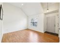 Bright living room featuring hardwood floors, vaulted ceilings, and a large window at 7033 Brecken Trce, Lithonia, GA 30058