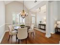 Elegant dining room with wood floors and a modern chandelier fixture at 8010 Majors Mill Dr, Cumming, GA 30041