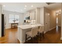 Bright kitchen with white cabinets, stainless appliances, and a breakfast bar at 8010 Majors Mill Dr, Cumming, GA 30041