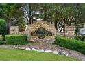 Stone sign for Bishop's Glen community, surrounded by manicured greenery and landscaping at 828 Ivy Ne Cv, Norcross, GA 30071