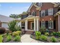 Inviting home exterior showcasing a cozy covered front porch and lush, landscaped garden beds at 828 Ivy Ne Cv, Norcross, GA 30071