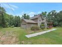 View of home showing lawn, stone accents, and two-car attached garage at 133 Harold Dr, Mcdonough, GA 30253