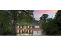 Charming two-story brick home with a two-car garage, surrounded by lush trees and greenery at 3130 Crestmont Nw Way, Kennesaw, GA 30152