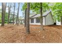 Side view of a single-story house with dark shutters and white siding at 40 Melton Way, Covington, GA 30016