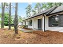 Sideways view of a well-kept single-story house with a black front door and shutters at 40 Melton Way, Covington, GA 30016