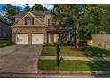 Charming two-story home with well-manicured lawn, two-car garage and tree lined yard at 7601 Watson Cir, Locust Grove, GA 30248