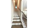 Elegant staircase featuring dark wood steps with white risers and a sleek, modern railing at , Covington, GA 30014