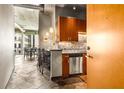 Modern kitchen featuring stone floors, stainless steel appliances, and a breakfast bar at 943 Peachtree Ne St # 2001, Atlanta, GA 30309