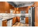 Well-equipped kitchen boasts stainless steel appliances, granite countertops, and sleek wooden cabinetry at 943 Peachtree Ne St # 2001, Atlanta, GA 30309