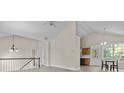 Open-concept living space with vaulted ceilings, hardwood floors, and views into the kitchen area at 2140 Wildcat Cliff Ln, Lawrenceville, GA 30043