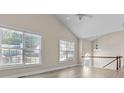 Bright living room with vaulted ceiling, hardwood floors, and large windows for ample natural light at 2140 Wildcat Cliff Ln, Lawrenceville, GA 30043