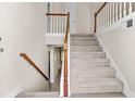Inviting foyer features a staircase with carpeted steps and wood railing leading to the upper level at 2140 Wildcat Cliff Ln, Lawrenceville, GA 30043