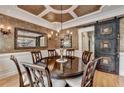 Formal dining room with coffered ceilings, hardwood floors, and decorative barn door at 3085 Saint Andrews Dr, Duluth, GA 30096