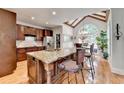 Eat-in kitchen featuring a large island, wood cabinets, and a sunlit breakfast nook at 3085 Saint Andrews Dr, Duluth, GA 30096