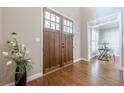 Grand foyer featuring double doors, hardwood floors, and views into the adjacent living spaces at 3440 Canyon Oak Way, Cumming, GA 30041