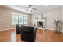 Bright living room with a fireplace, hardwood floors, and plenty of natural light at 3440 Canyon Oak Way, Cumming, GA 30041
