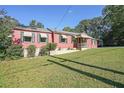 Inviting single-story home with classic awnings and a lush green lawn at 2055 Anderson Se Dr, Smyrna, GA 30080