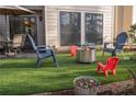 Charming backyard featuring artificial turf, colorful seating, and a modern fire pit for outdoor enjoyment at 4846 Twin Lakes Trl, Atlanta, GA 30360