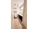 Well-lit bathroom featuring vanity, toilet, shelving, and neutral colors at 4846 Twin Lakes Trl, Atlanta, GA 30360